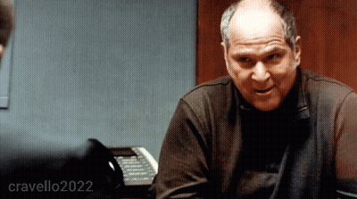 A Man Sitting At A Desk With The Year 2022 Written On The Bottom GIF