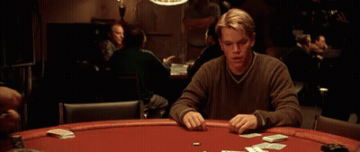 A Man Sitting At A Poker Table With Cards And Chips GIF