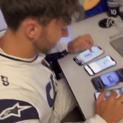 A Man Sitting At A Table Looking At A Cell Phone With The Number 10 On It GIF