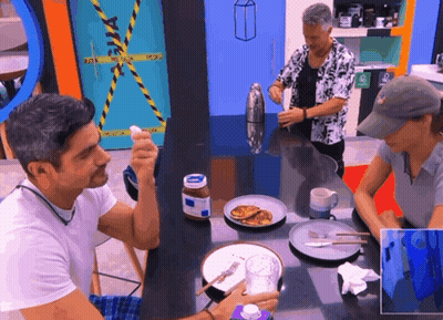A Man Sitting At A Table With A Bottle Of Nutella GIF