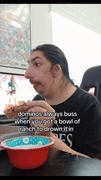 A Man Sitting At A Table With A Bowl Of Ranch And A Bowl Of Domino 'S GIF