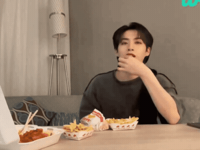 A Man Sitting At A Table With A Box Of Wendy 'S French Fries On It GIF