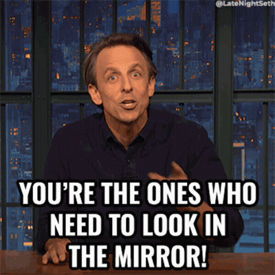 A Man Sitting At A Table With A Caption That Says You 'Re The Ones Who Need To Look In The Mirror GIF