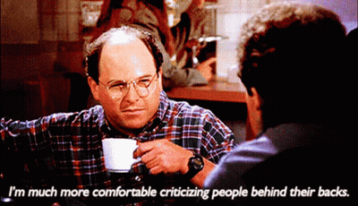 A Man Sitting At A Table With A Cup Of Coffee Says I 'M Much More Comfortable Criticizing People GIF