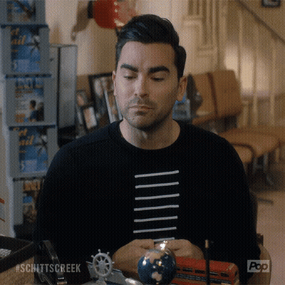A Man Sitting At A Table With A Globe And A Pop Logo On The Bottom Right GIF