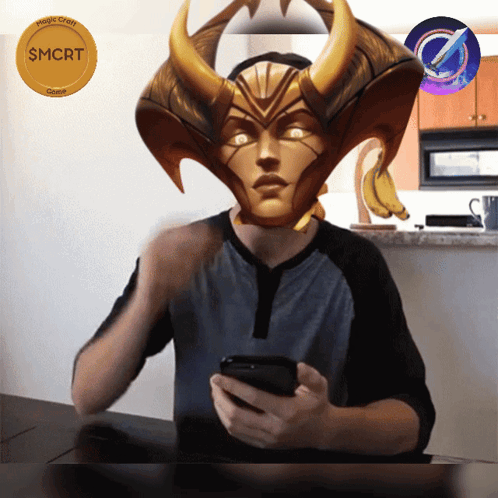 A Man Sitting At A Table With A Mask On His Head That Says Smrt On It GIF