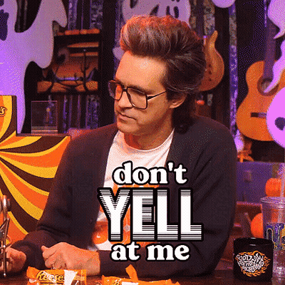 A Man Sitting At A Table With A Sign That Says " Do N't Yell At Me " On It GIF