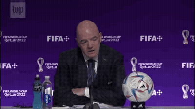A Man Sitting At A Table With A Soccer Ball That Says Today I Feel On It GIF