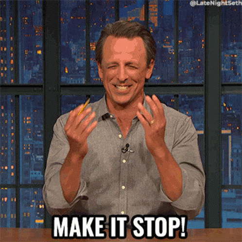 A Man Sitting At A Table With Make It Stop Written On The Screen GIF