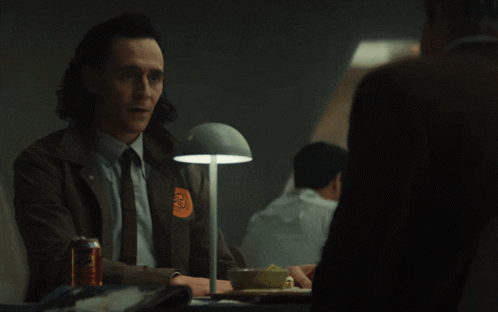 A Man Sitting At A Table With The Word Anyway On The Bottom Right GIF