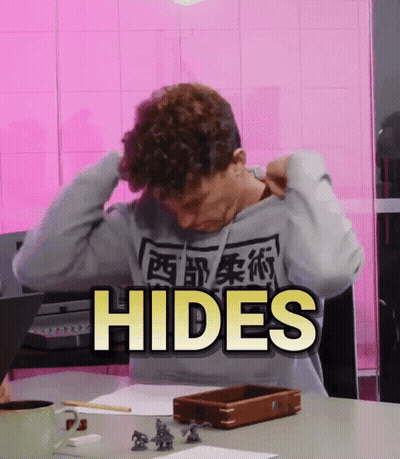A Man Sitting At A Table With The Word Hides Written On The Bottom GIF