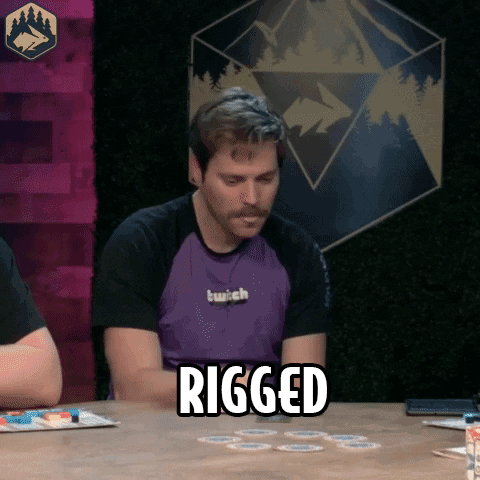 A Man Sitting At A Table With The Word Rigged Written On It GIF