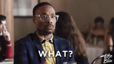 A Man Sitting At A Table With The Word What Written On His Face GIF