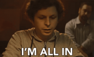 A Man Sitting At A Table With The Words I 'M All In Written On His Face GIF