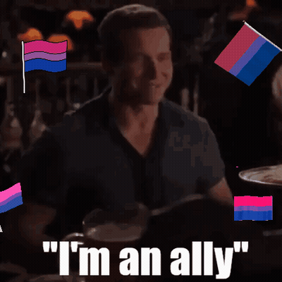 A Man Sitting At A Table With The Words " I 'M An Ally " GIF