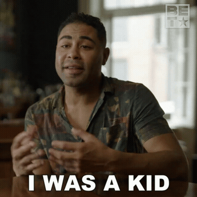A Man Sitting At A Table With The Words I Was A Kid In Front Of Him GIF