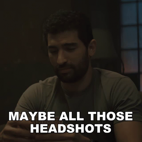 A Man Sitting At A Table With The Words " Maybe All Those Headshots " Written Below Him GIF