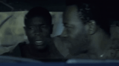 A Man Sitting In A Car With The Words Course I Am Above His Head GIF