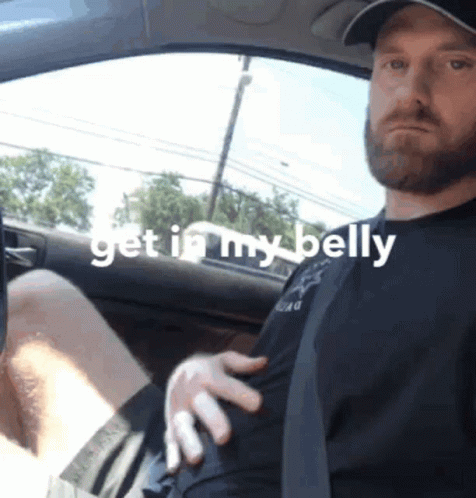 A Man Sitting In A Car With The Words Get In My Belly On The Bottom GIF