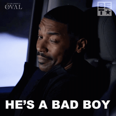 A Man Sitting In A Car With The Words He 'S A Bad Boy Below Him GIF