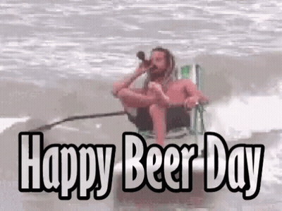 A Man Sitting In A Chair Drinking Beer With The Words Happy Beer Day GIF