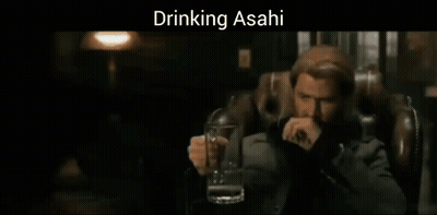A Man Sitting In A Chair Holding A Glass Of Beer With The Words Drinking Asahi Above Him GIF