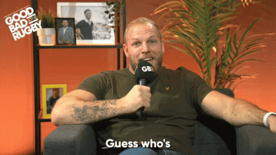 A Man Sitting In A Chair Holding A Microphone That Says Gb GIF
