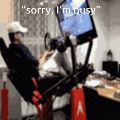 A Man Sitting In A Chair Playing A Video Game With The Words " Sorry I 'M Busy " GIF