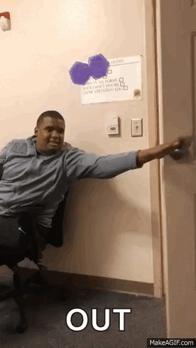 A Man Sitting In A Chair Reaching Out To Open A Door With The Word Out Written On The Bottom GIF