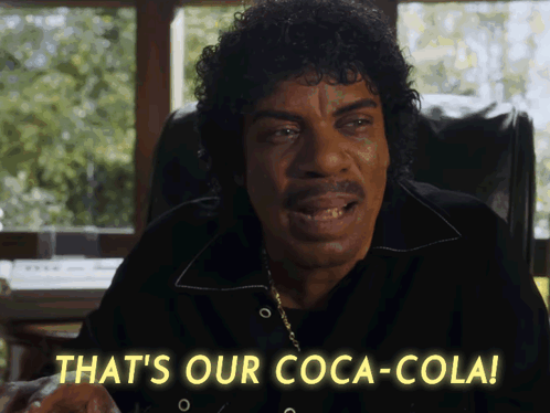 A Man Sitting In A Chair Says That 'S Our Coca Cola GIF