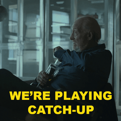 A Man Sitting In A Chair With A Bottle Of Beer And The Words We 'Re Playing Catch-Up Above Him GIF