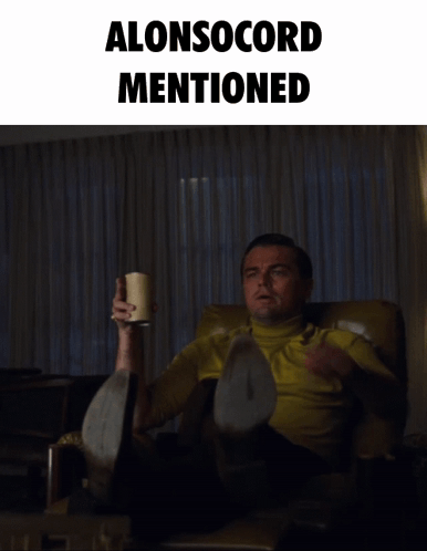 A Man Sitting In A Chair With A Cup In His Hand And The Words Alonsocord Mentioned Behind Him GIF