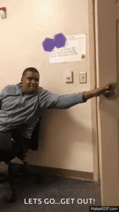 A Man Sitting In A Chair With His Arm Outstretched And A Sign On The Wall That Says " Let 'S Go " GIF