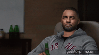 A Man Sitting In A Chair With His Feet Up And A Bottle Of Beer GIF