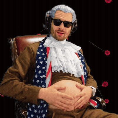 A Man Sitting In A Chair With His Hands On His Belly Wearing An American Flag Scarf GIF