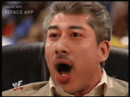 A Man Sitting In A Chair With His Mouth Open And A Wrestlemania Logo On His Chest GIF