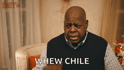 A Man Sitting In A Chair With The Word Whew Chile Written On His Chest GIF