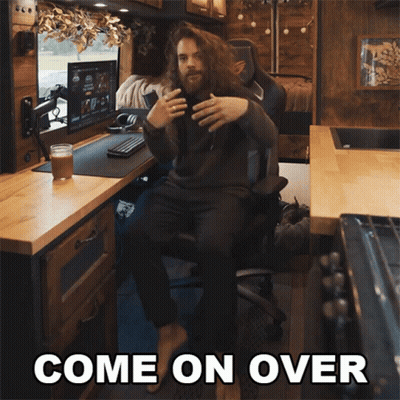 A Man Sitting In A Chair With The Words Come On Over Written Above Him GIF