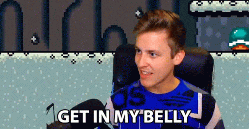 A Man Sitting In A Chair With The Words Get In My Belly Written Below Him GIF