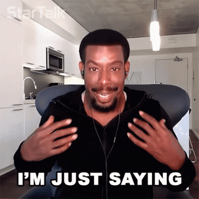 A Man Sitting In A Chair With The Words " I 'M Just Saying " On The Bottom GIF