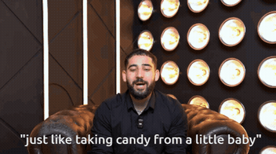 A Man Sitting In A Chair With The Words " Just Like Taking Candy From A Little Baby " On The Bottom GIF