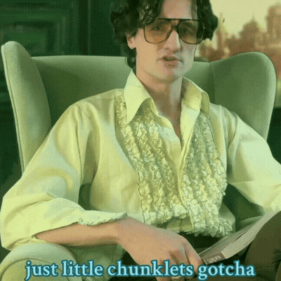 A Man Sitting In A Chair With The Words Just Little Chunklets Gotcha Written Below Him GIF