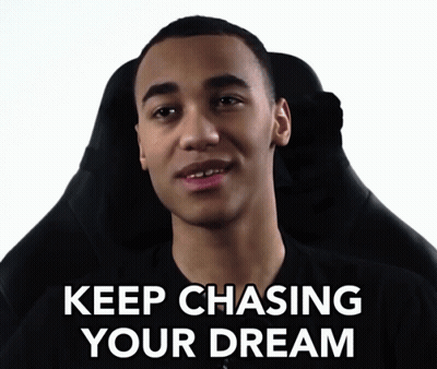 A Man Sitting In A Chair With The Words " Keep Chasing Your Dream " Written Below Him GIF
