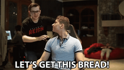 A Man Sitting In A Chair With The Words Let 'S Get This Bread Behind Him GIF