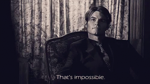 A Man Sitting In A Chair With The Words That 'S Impossible On The Bottom GIF
