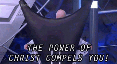 A Man Sitting In A Chair With The Words " The Power Of Christ Compels You " GIF