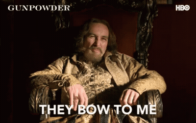 a man sitting in a chair with the words " they bow to me " written on the bottom