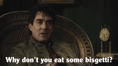 A Man Sitting In A Chair With The Words " Why Don T You Eat Some Bisgetti " GIF