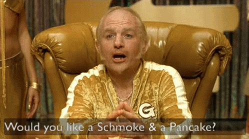 A Man Sitting In A Chair With The Words Would You Like A Schmoke And A Pancake GIF
