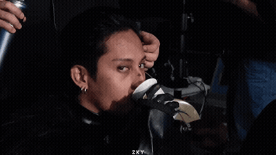 A Man Sitting In A Chair With Zky Written On The Bottom Right GIF